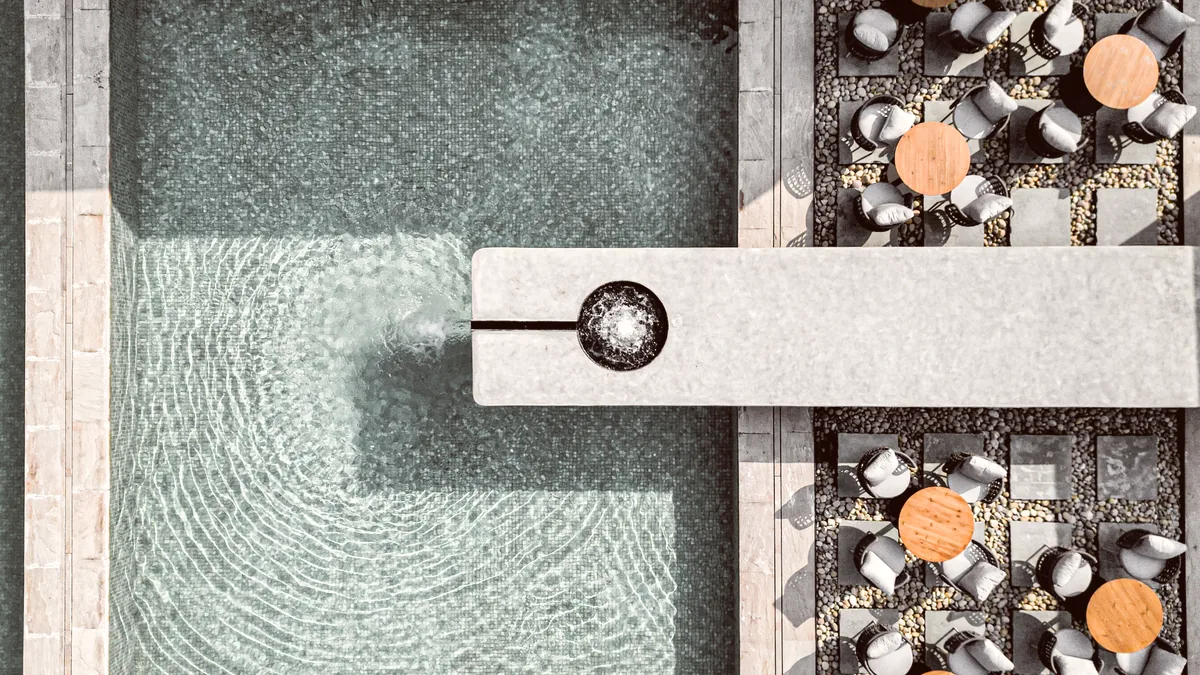 Naturoville Wellness Resort from the air, its pool and terraces below