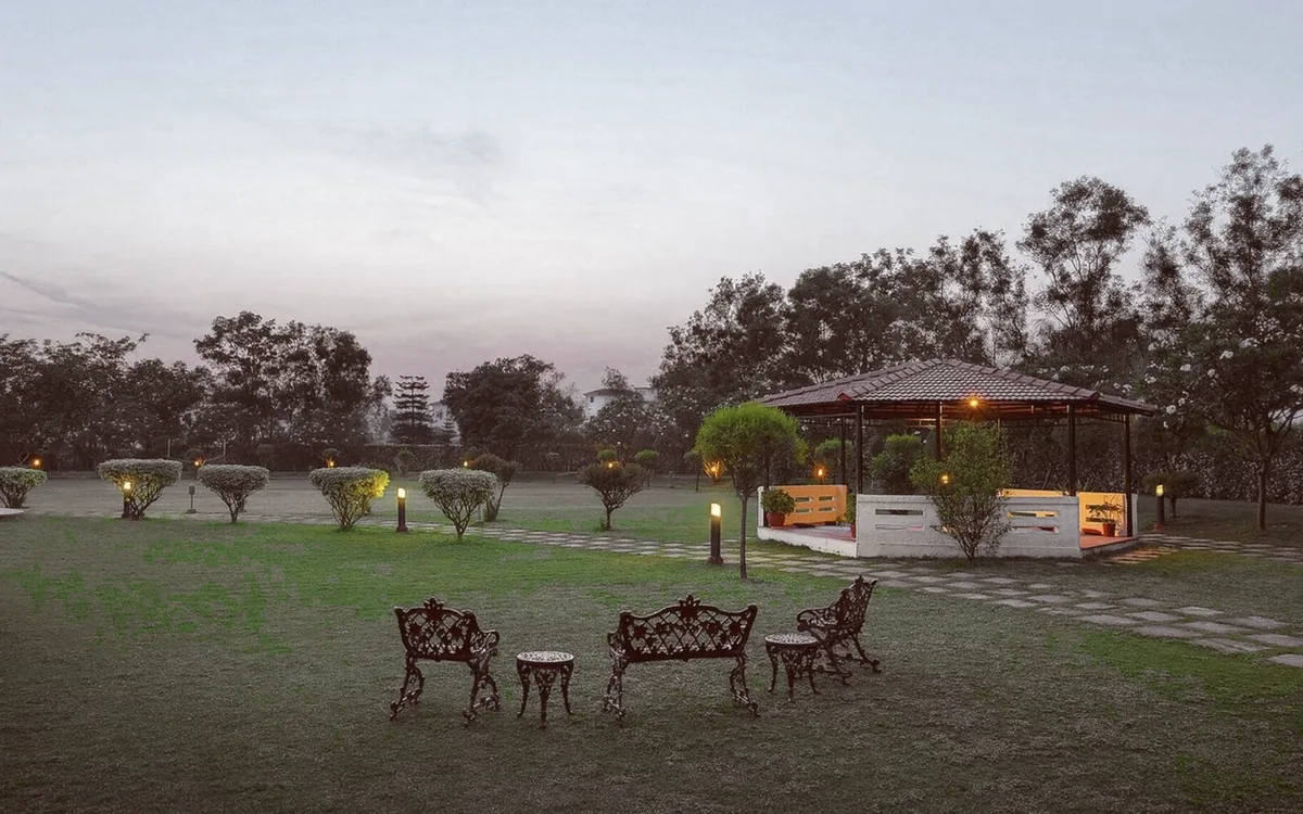 The lawn at Naturoville at dusk, seating out under the trees