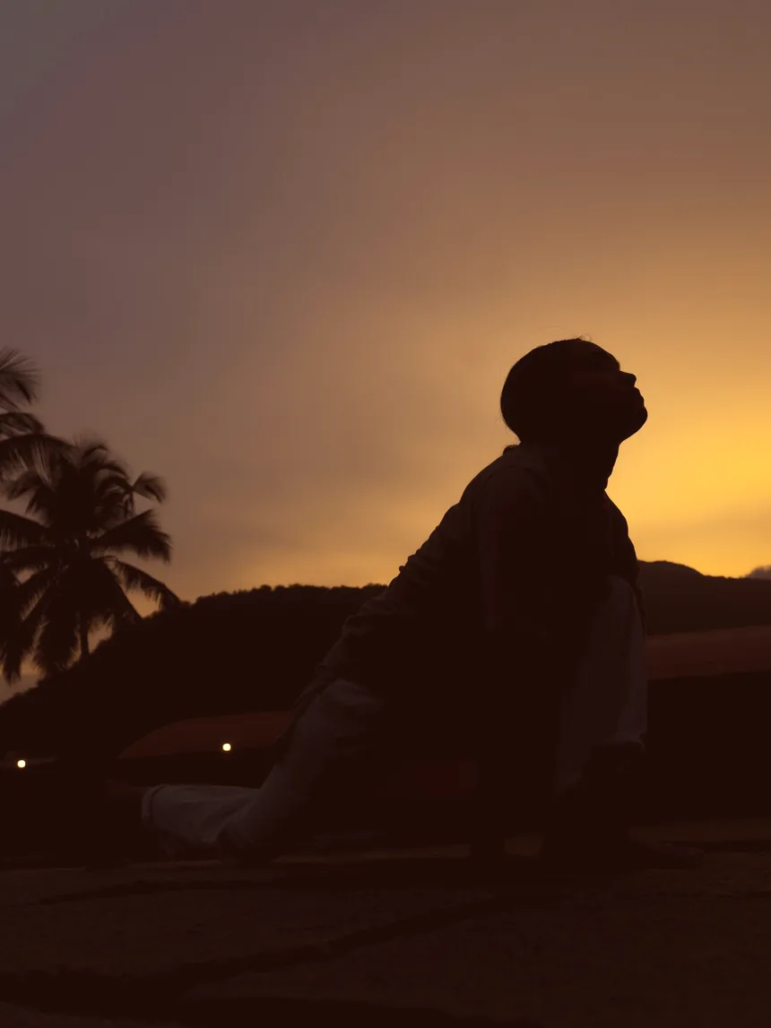 A lone figure arched back in practice against a dusk sky