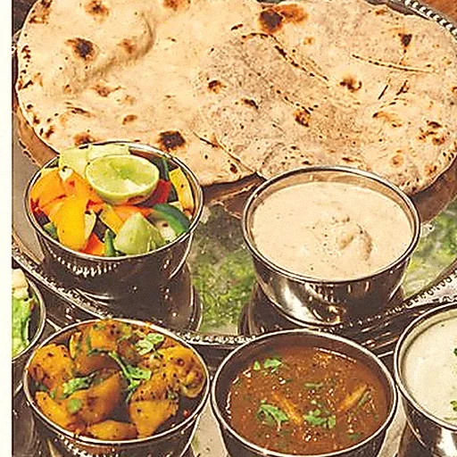 A thali of dal, sabzi, curd and fresh rotis