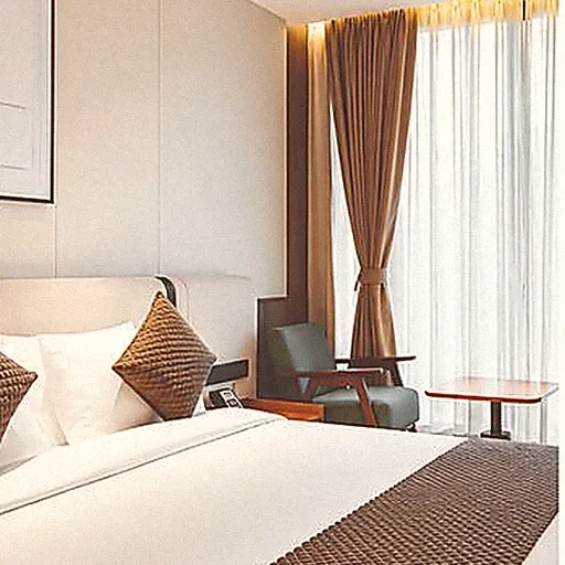 A retreat bedroom made up in white and brown linen